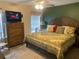 Spacious main bedroom with a king-size bed and dresser at 6704 N 13Th St, Tampa, FL 33604