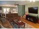 Open living space with hardwood floors and TV at 6704 N 13Th St, Tampa, FL 33604