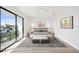 Main bedroom with a king-size bed and access to a private balcony at 116 Wimbledon Ct, Redington Shores, FL 33708