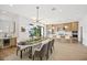 Bright dining room with modern table and chairs, adjacent to a stylish kitchen at 116 Wimbledon Ct, Redington Shores, FL 33708