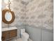 Stylish powder room with patterned wallpaper and modern vanity at 116 Wimbledon Ct, Redington Shores, FL 33708