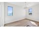 Spacious bedroom with large windows, hardwood floors, and chandelier at 116 Wimbledon Ct, Redington Shores, FL 33708