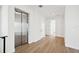 Bright hallway with hardwood floors and interior elevator access at 116 Wimbledon Ct, Redington Shores, FL 33708
