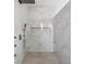 Spa-like shower with a large walk-in design and marble tile at 116 Wimbledon Ct, Redington Shores, FL 33708