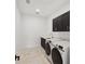 Bright laundry room with dark cabinetry and new Samsung appliances at 116 Wimbledon Ct, Redington Shores, FL 33708
