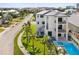 Back exterior of modern home showcasing pool and landscaping at 116 Wimbledon Ct, Redington Shores, FL 33708