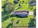 Aerial view of a ranch-style home on large lot with pool and outbuildings at 8016 Carey Rd, Lithia, FL 33547