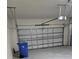 Garage with automatic door opener and a blue recycling bin at 16988 Oval Rum Dr, Wimauma, FL 33598