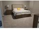 Main bedroom with a king-size bed, carpet flooring, and nightstands at 16988 Oval Rum Dr, Wimauma, FL 33598