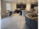 Open concept kitchen with island and living room view at 16988 Oval Rum Dr, Wimauma, FL 33598