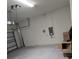Empty garage with automatic door opener and concrete floor at 16988 Oval Rum Dr, Wimauma, FL 33598