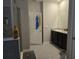 Bathroom with shower, double vanity, and dark brown cabinets at 16988 Oval Rum Dr, Wimauma, FL 33598