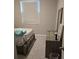 Bedroom with gray carpet, a queen bed, and dresser at 16988 Oval Rum Dr, Wimauma, FL 33598