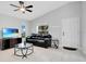 Living room with tile floors, black leather couches, and a large TV at 1110 W Madison St, Plant City, FL 33563