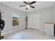 Light-filled bedroom with window, ceiling fan and double door closet at 1110 W Madison St, Plant City, FL 33563