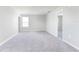 Neutral-toned bedroom with gray carpet and an open doorway at 12332 Marshland St, Riverview, FL 33579