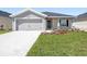 Charming single-story home featuring a well-maintained lawn, neutral paint, and a two-car garage at 7011 161St E Ter, Parrish, FL 34219