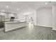Open-concept living space showcasing the kitchen with stainless steel appliances, granite countertops, and ample cabinetry at 7011 161St E Ter, Parrish, FL 34219
