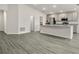 Bright kitchen featuring stainless steel appliances, a spacious island with granite countertops, and hardwood floors at 7011 161St E Ter, Parrish, FL 34219