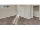 Bright bedroom with double doors, carpet, and an arched window at 10469 Meadowrun Dr, Lithia, FL 33547