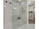 Large walk-in shower with glass enclosure and pebble floor at 10469 Meadowrun Dr, Lithia, FL 33547