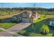 Two-story home with tile roof, driveway, and landscaped yard at 10469 Meadowrun Dr, Lithia, FL 33547