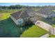 Two story house, tile roof and driveway, next to other homes at 10469 Meadowrun Dr, Lithia, FL 33547