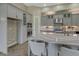 Modern kitchen with gray cabinets, quartz countertops and herringbone floors at 10469 Meadowrun Dr, Lithia, FL 33547