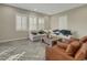 Living room with herringbone flooring, a sectional sofa, and two armchairs at 10469 Meadowrun Dr, Lithia, FL 33547