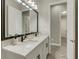 Double vanity bathroom with modern fixtures and mirror at 10469 Meadowrun Dr, Lithia, FL 33547