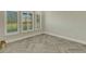 Spacious room with herringbone floors, plantation shutters, and bright natural light at 10469 Meadowrun Dr, Lithia, FL 33547
