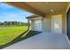 Covered patio with access to backyard and open green space at 10469 Meadowrun Dr, Lithia, FL 33547
