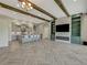 Open concept kitchen and living space with herringbone floors and exposed beams at 10469 Meadowrun Dr, Lithia, FL 33547