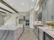 Open concept kitchen with island, stainless steel appliances, and white quartz countertops at 10469 Meadowrun Dr, Lithia, FL 33547