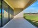 Covered patio with sliding glass doors and view of backyard at 10469 Meadowrun Dr, Lithia, FL 33547