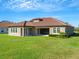 One-story house with tile roof and landscaped backyard at 10469 Meadowrun Dr, Lithia, FL 33547