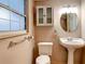 Traditional bathroom with pedestal sink, medicine cabinet, and window at 5260 42Nd S St, St Petersburg, FL 33711