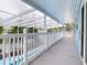 Long covered deck, view of backyard and pool, white railing at 5260 42Nd S St, St Petersburg, FL 33711
