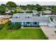Aerial view of a charming blue home, garage, well-kept lawn and landscaped yard at 5260 42Nd S St, St Petersburg, FL 33711