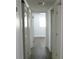 Hallway with modern flooring and fresh white paint, leading to other rooms at 5260 42Nd S St, St Petersburg, FL 33711
