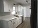 Clean white kitchen showcasing stainless steel appliances and sleek design at 5260 42Nd S St, St Petersburg, FL 33711