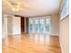 Spacious living room featuring hardwood floors, ceiling fan, and sliding doors to the porch at 5260 42Nd S St, St Petersburg, FL 33711