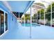 Outdoor pool with blue flooring, caged for privacy, and connected to the house at 5260 42Nd S St, St Petersburg, FL 33711