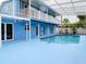 Exterior view of a blue two-story house with a covered pool and second-story balcony at 5260 42Nd S St, St Petersburg, FL 33711