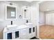 Double vanity bathroom with updated fixtures and a view of a bedroom at 8613 Beth Ct, Odessa, FL 33556