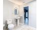 Clean bathroom with pedestal sink and tiled floor at 8613 Beth Ct, Odessa, FL 33556