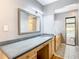 Double vanity bathroom with gray countertop and access to the pool at 8613 Beth Ct, Odessa, FL 33556