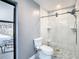 Updated bathroom with a walk-in shower, toilet and view of the backyard at 8613 Beth Ct, Odessa, FL 33556