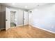 Bedroom with light gray walls, wood flooring, and access to a bathroom at 8613 Beth Ct, Odessa, FL 33556