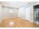 Bright bedroom with wood flooring, a window, and access to a bathroom at 8613 Beth Ct, Odessa, FL 33556